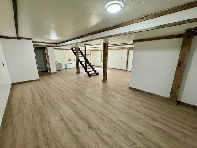 a view of a room with wooden floor
