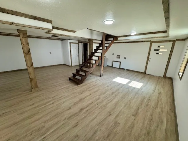 en empty room with windows and entrance