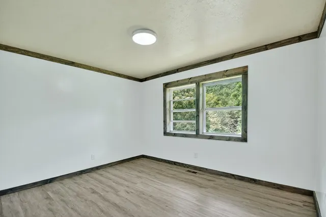 a bathroom with a granite countertop sink and a large mirror