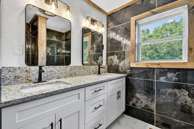a bathroom with a glass shower door