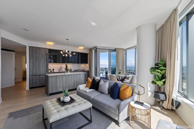 a living room with furniture and a chandelier
