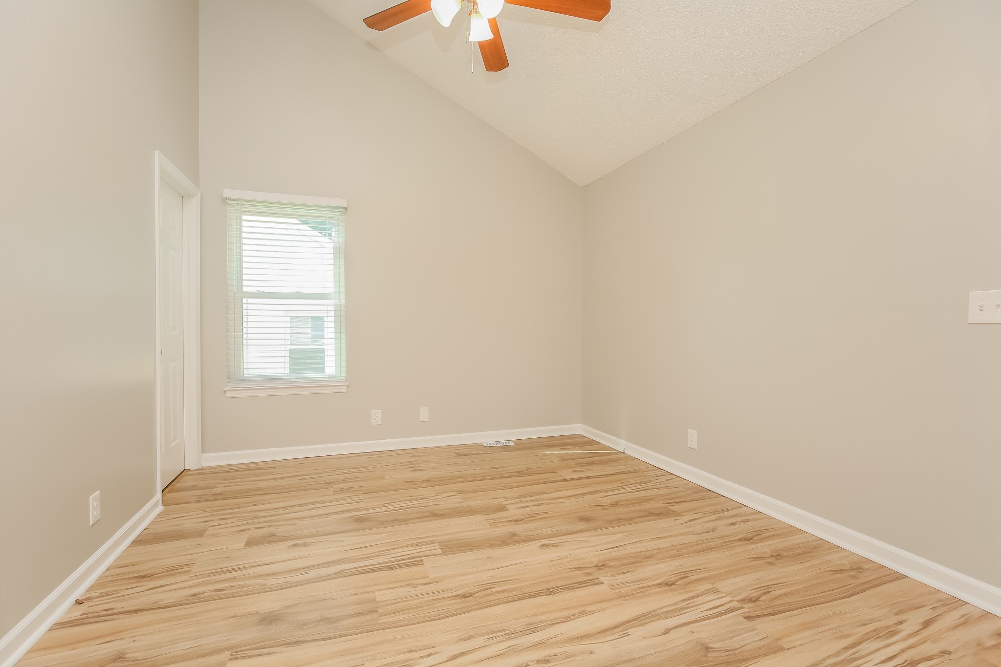 1416 Mohawk Trail Madison, TN 37115 - Photo 8 of 16 a view of an empty room with wooden floor and a window