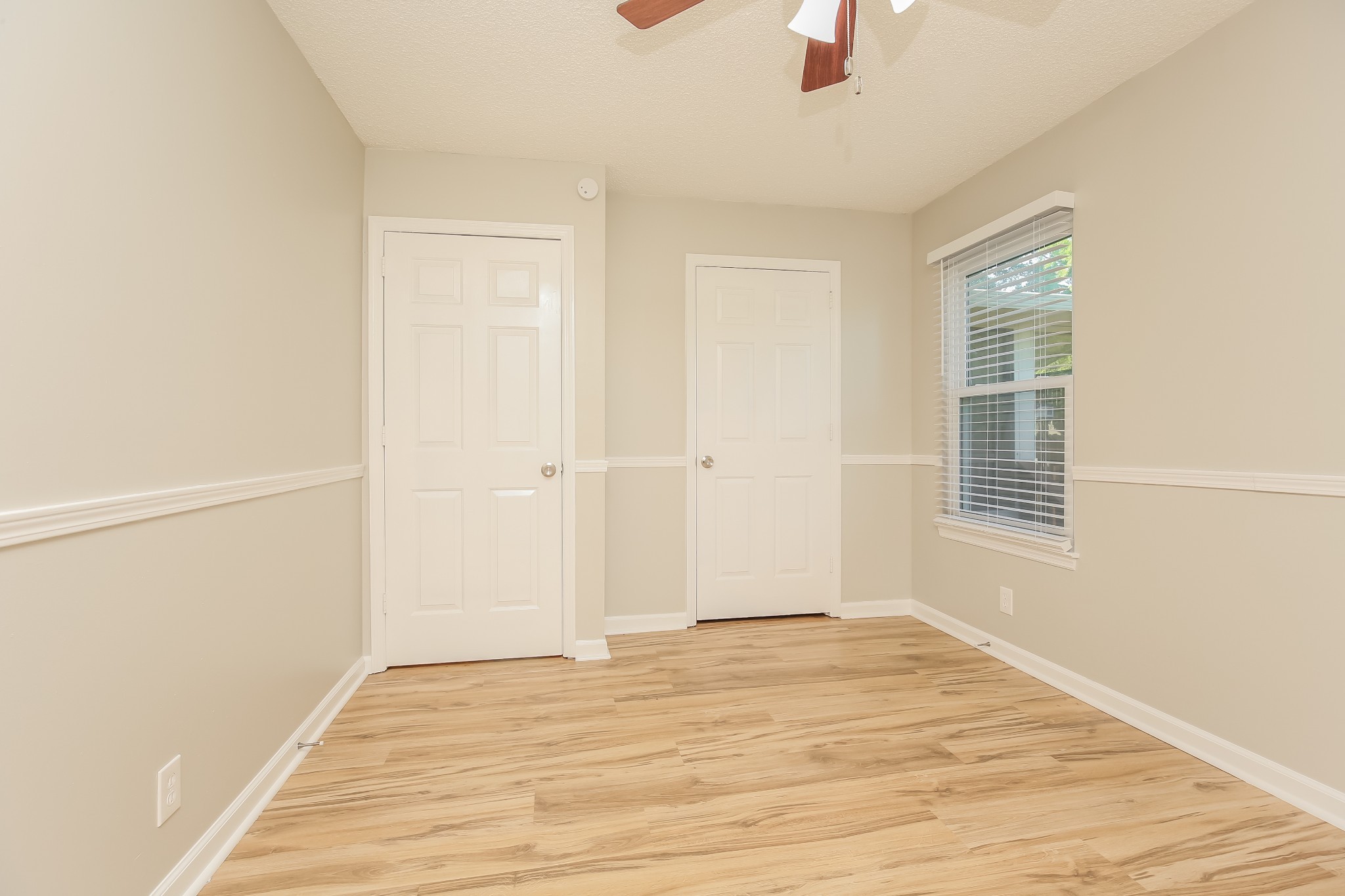 1416 Mohawk Trail Madison, TN 37115 - Photo 10 of 16 an empty room with wooden floor cabinet and windows