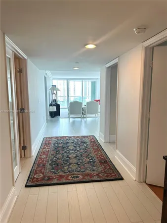a living room with furniture a large window and a flat screen tv