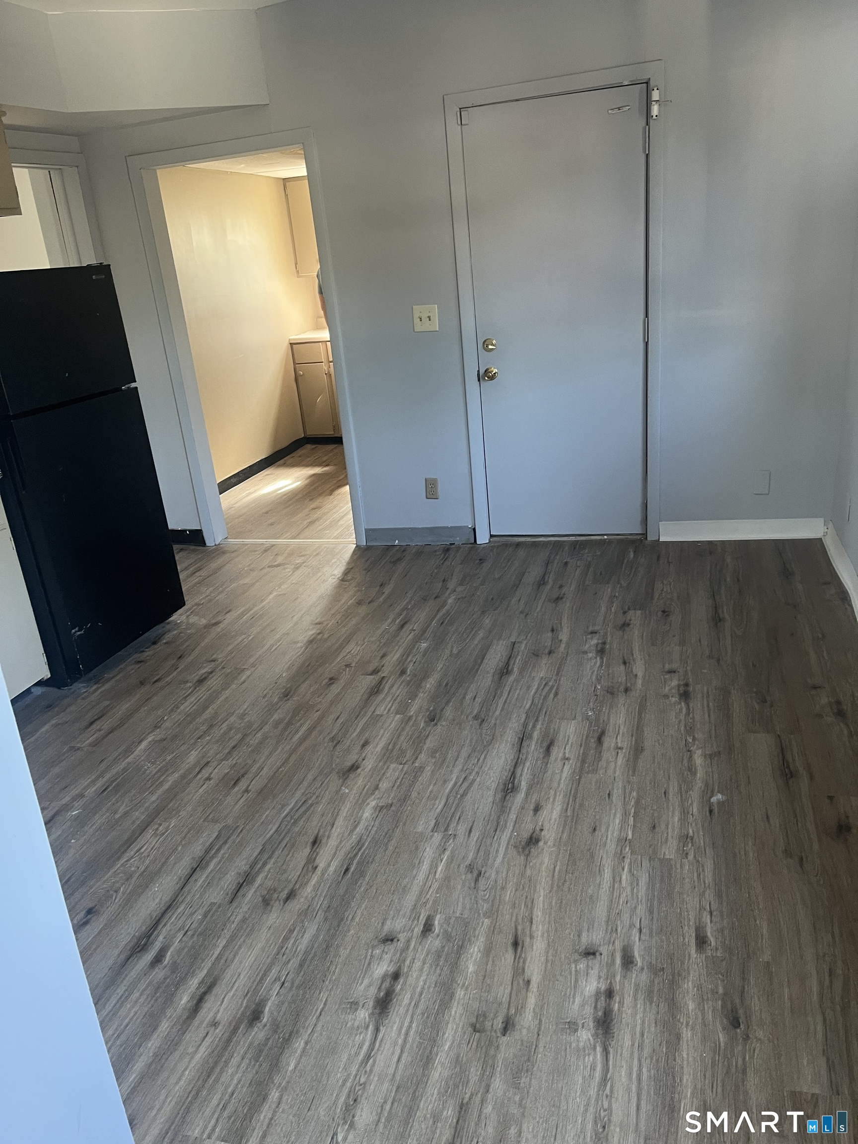 288 Cook Avenue Meriden, CT 06451 - Photo 7 of 11 an empty room with wooden floor and windows