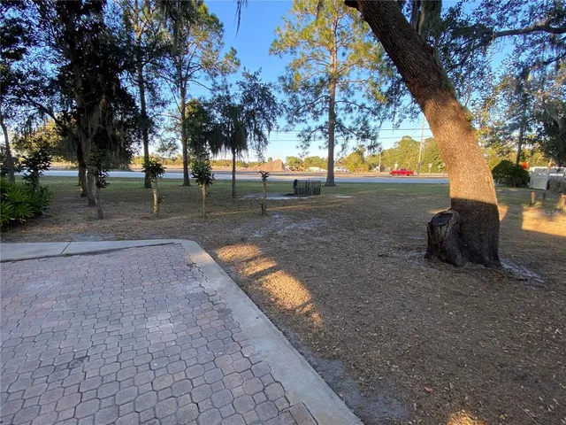 a view of a house with backyard sitting area and garden