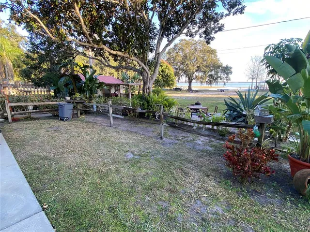 a backyard of a house with yard and outdoor seating