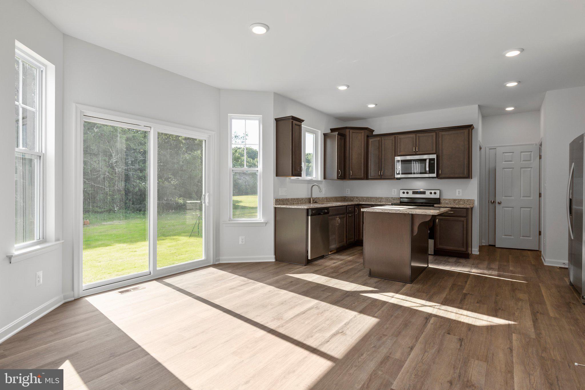 2 Indiantown Road King George, VA 22485 - Photo 8 of 27 a kitchen with stainless steel appliances kitchen island granite countertop a refrigerator a sink a stove top oven and a granite counter tops