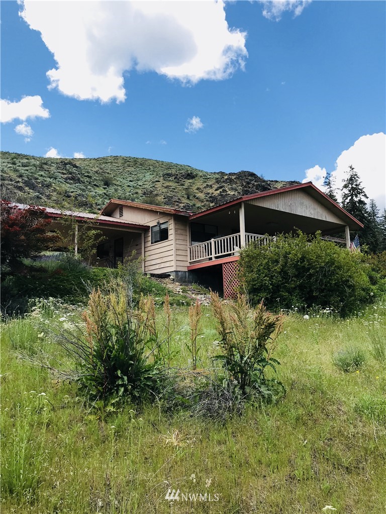 803 Twisp Carlton Road, Unit B Twisp, WA 98856 - Photo 1 of 25 a view of a house with a yard