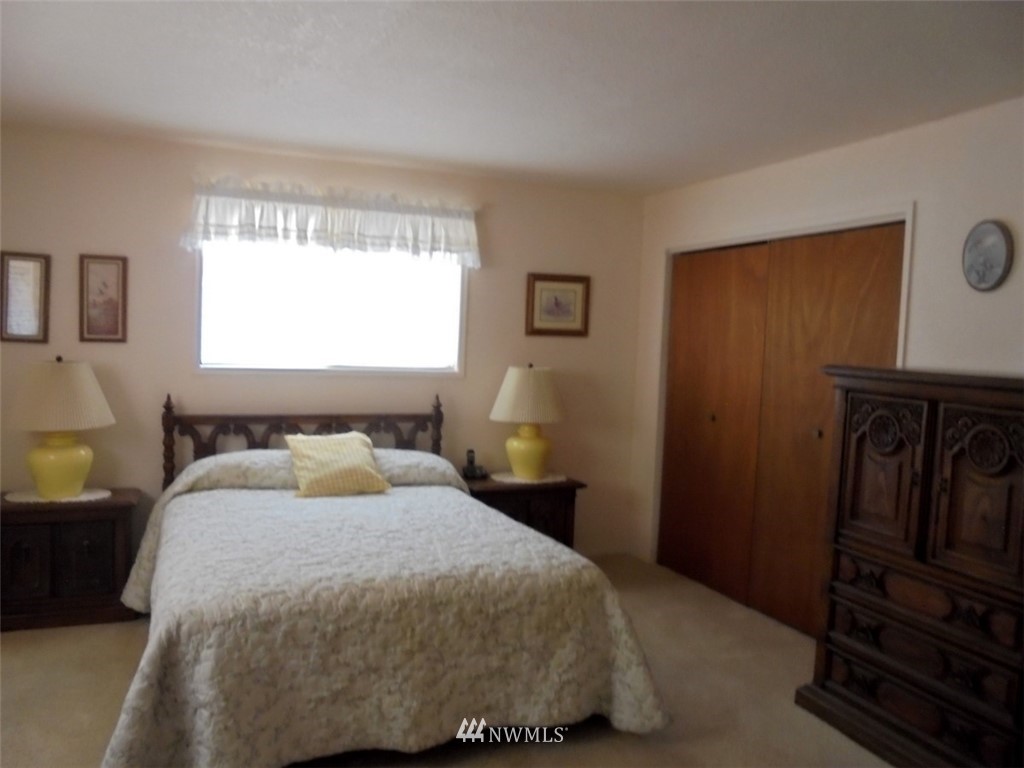 803 Twisp Carlton Road, Unit B Twisp, WA 98856 - Photo 14 of 25 a bedroom with a bed and wooden floor