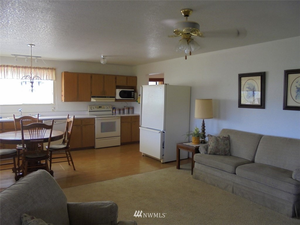 803 Twisp Carlton Road, Unit B Twisp, WA 98856 - Photo 8 of 25 a living room with furniture and a chandelier