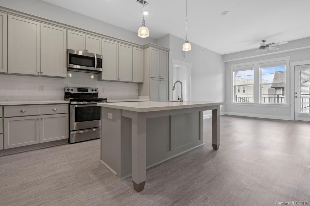 652 Herrons Ferry Road, Unit 419 Rock Hill, SC 29730 - Photo 13 of 36 a kitchen with stainless steel appliances granite countertop a stove a sink and a microwave