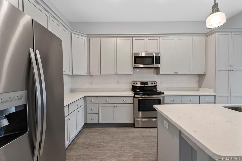 652 Herrons Ferry Road, Unit 419 Rock Hill, SC 29730 - Photo 14 of 36 a kitchen with stainless steel appliances granite countertop a refrigerator stove top oven and sink