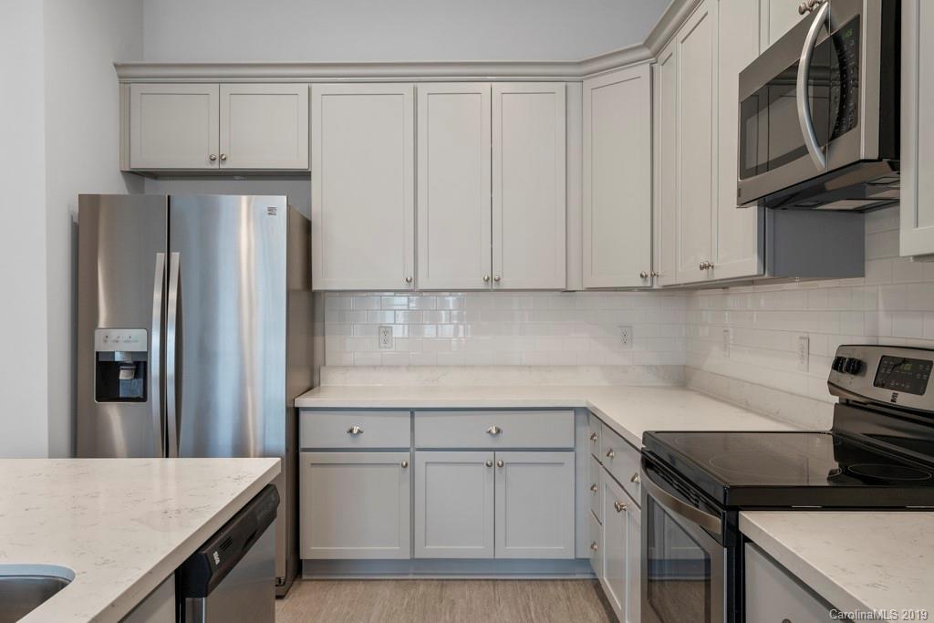 652 Herrons Ferry Road, Unit 419 Rock Hill, SC 29730 - Photo 19 of 36 a kitchen with stainless steel appliances granite countertop a refrigerator sink and stove