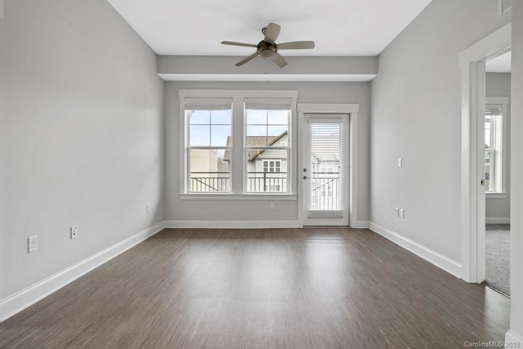 652 Herrons Ferry Road, Unit 419 Rock Hill, SC 29730 - Photo 23 of 36 a view of an empty room with wooden floor and a window