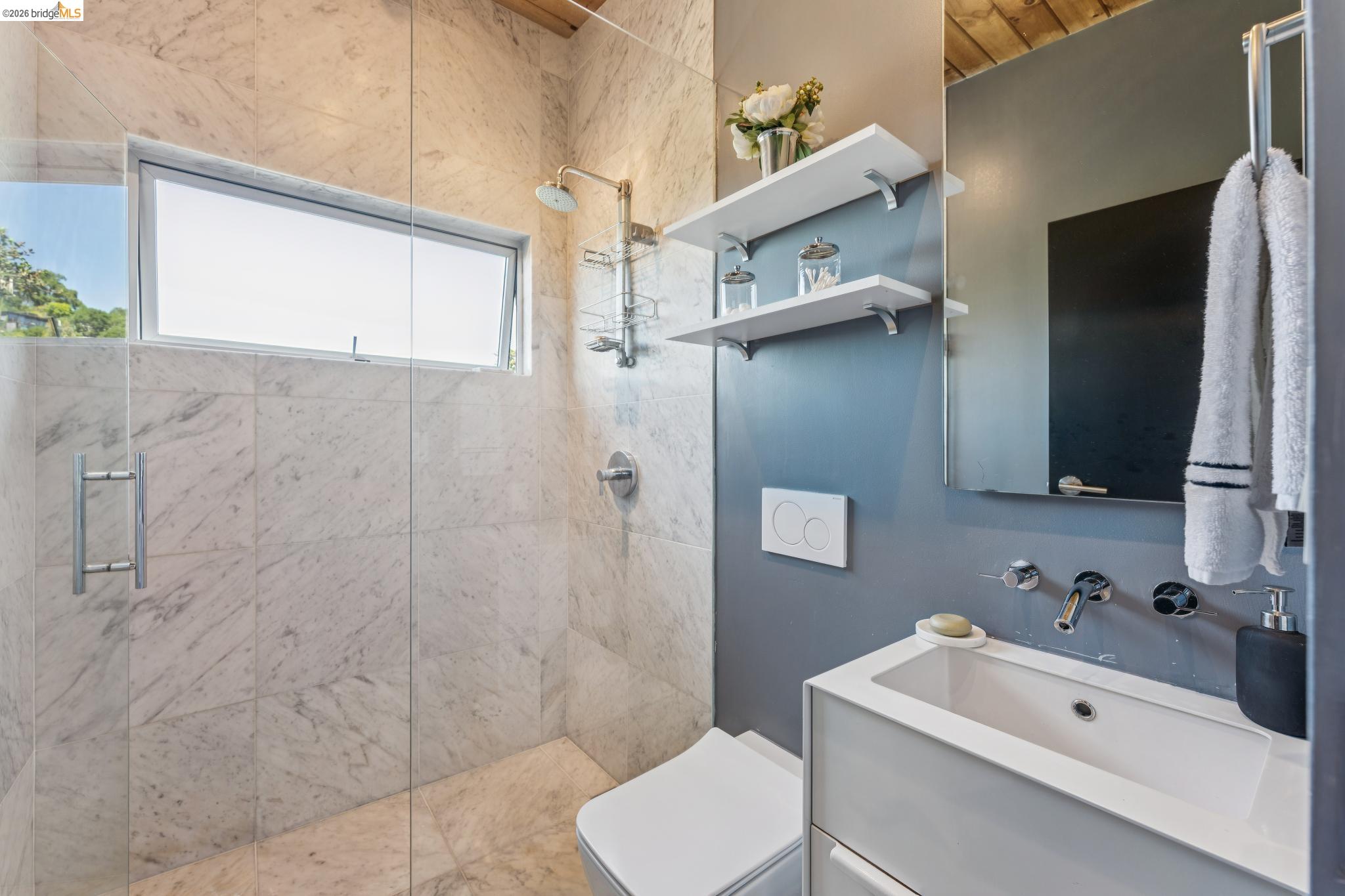 6733 Snake Road Oakland, CA 94611 - Photo 19 of 57 a bathroom with a sink a toilet and shower