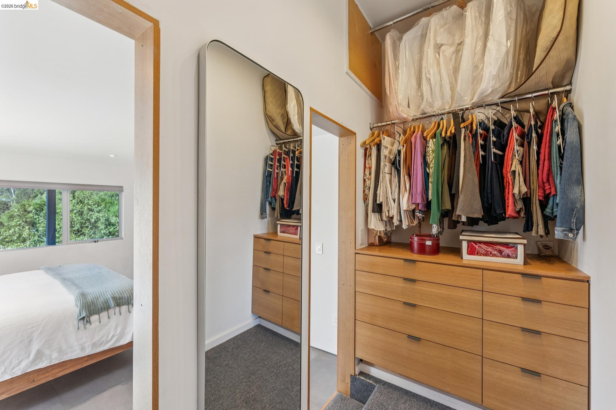 6733 Snake Road Oakland, CA 94611 - Photo 31 of 57 a view of walk in closet with clothes and shoes