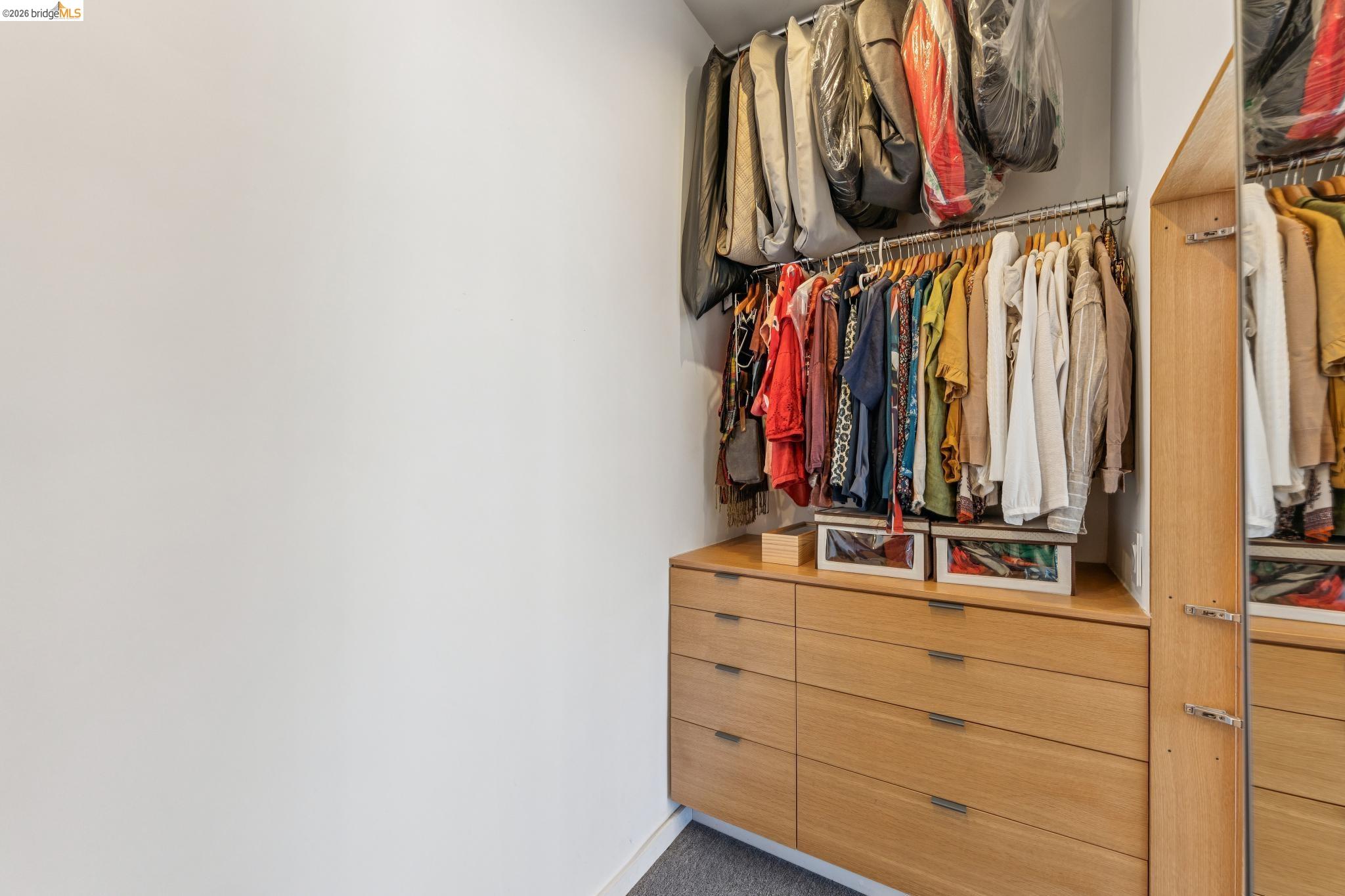 6733 Snake Road Oakland, CA 94611 - Photo 32 of 57 a view of walk in closet with clothes