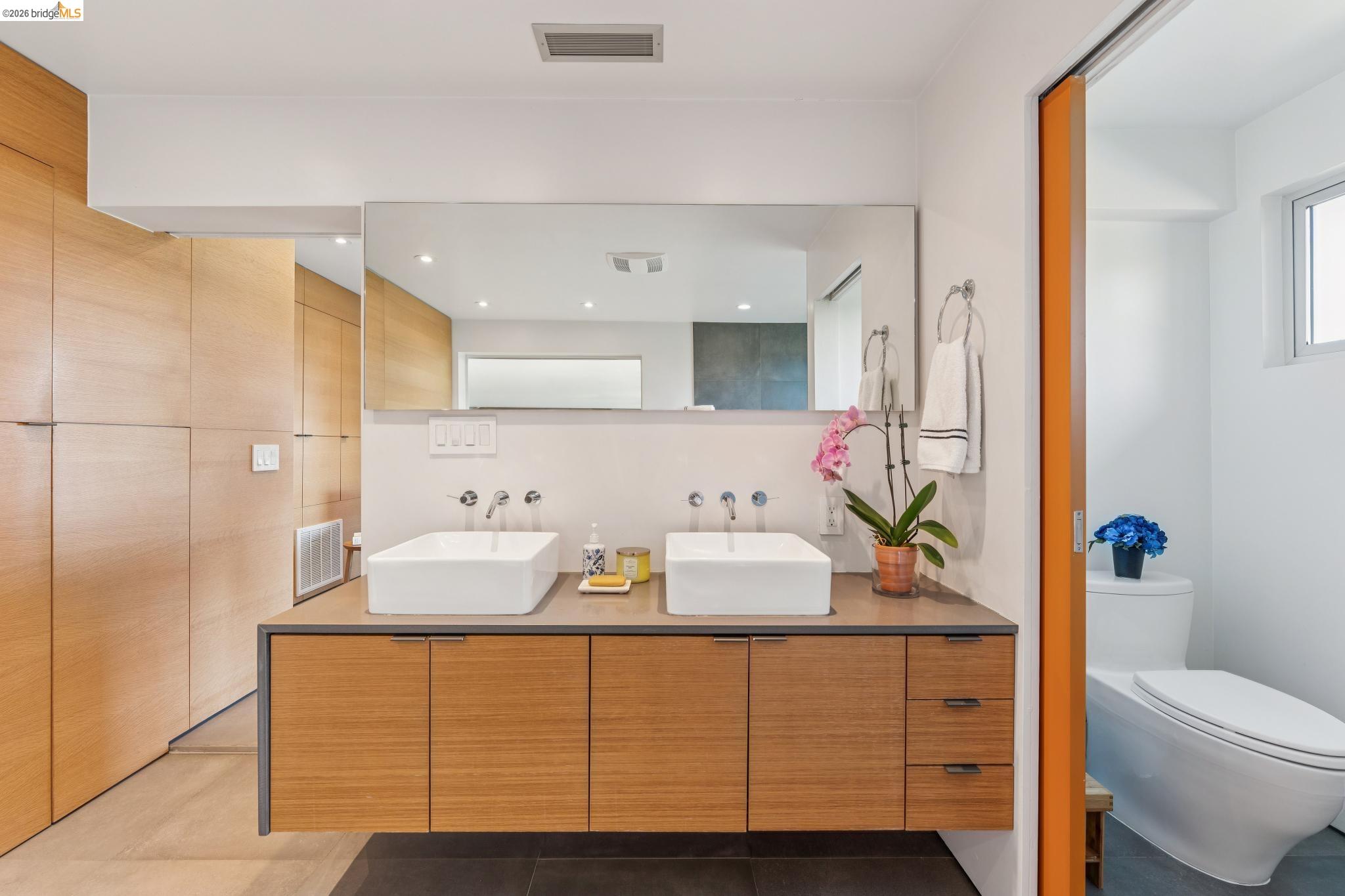 6733 Snake Road Oakland, CA 94611 - Photo 36 of 57 a bathroom with a sink double vanity and tub