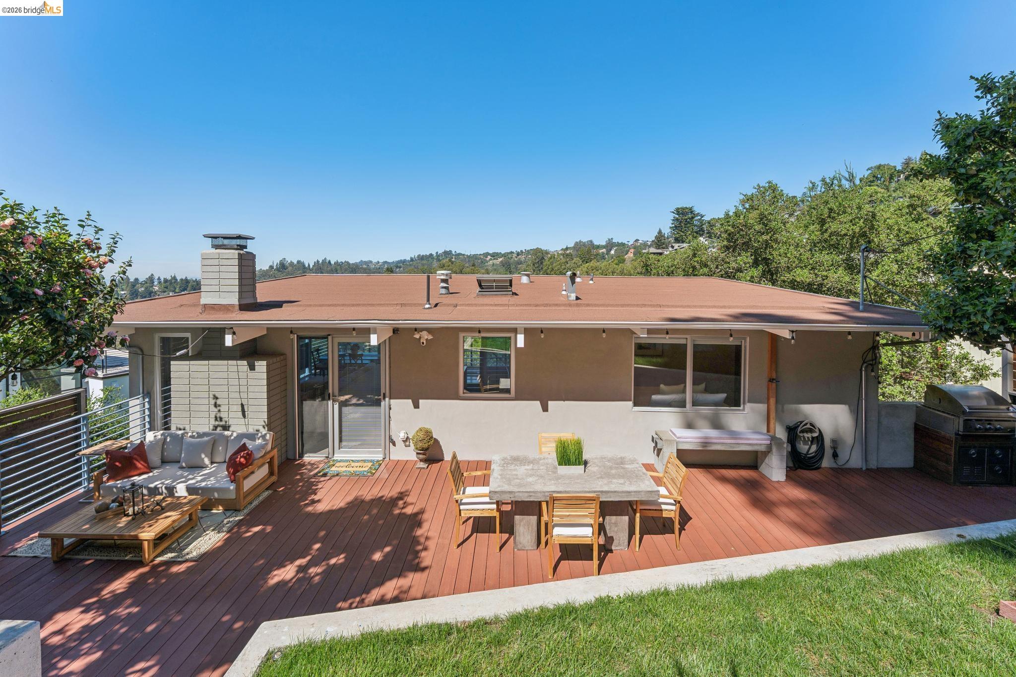 6733 Snake Road Oakland, CA 94611 - Photo 4 of 57 An outdoor seating area, patio table and an outdoor kitchen.