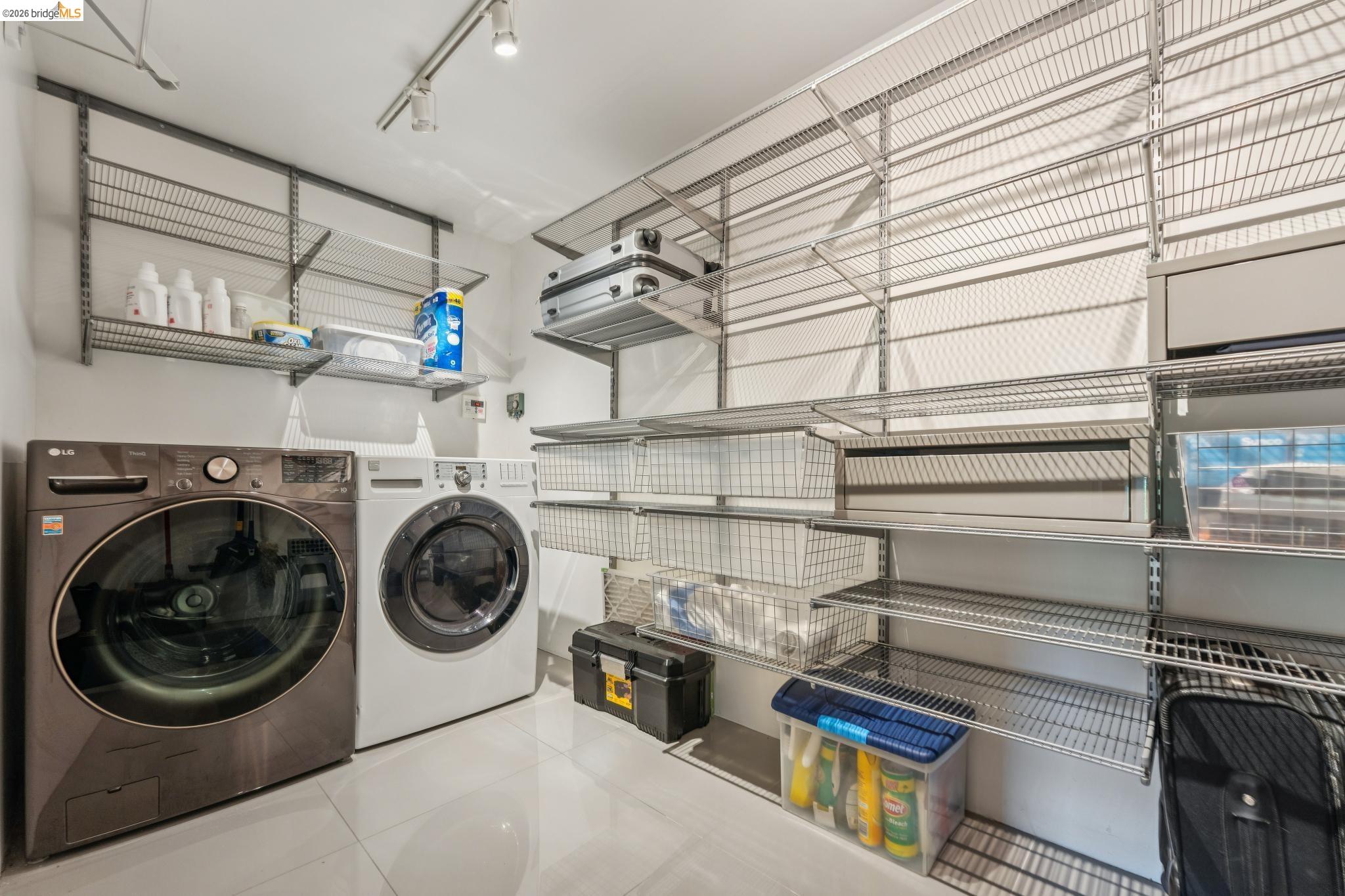 6733 Snake Road Oakland, CA 94611 - Photo 41 of 57 a utility room with sink dryer and washer