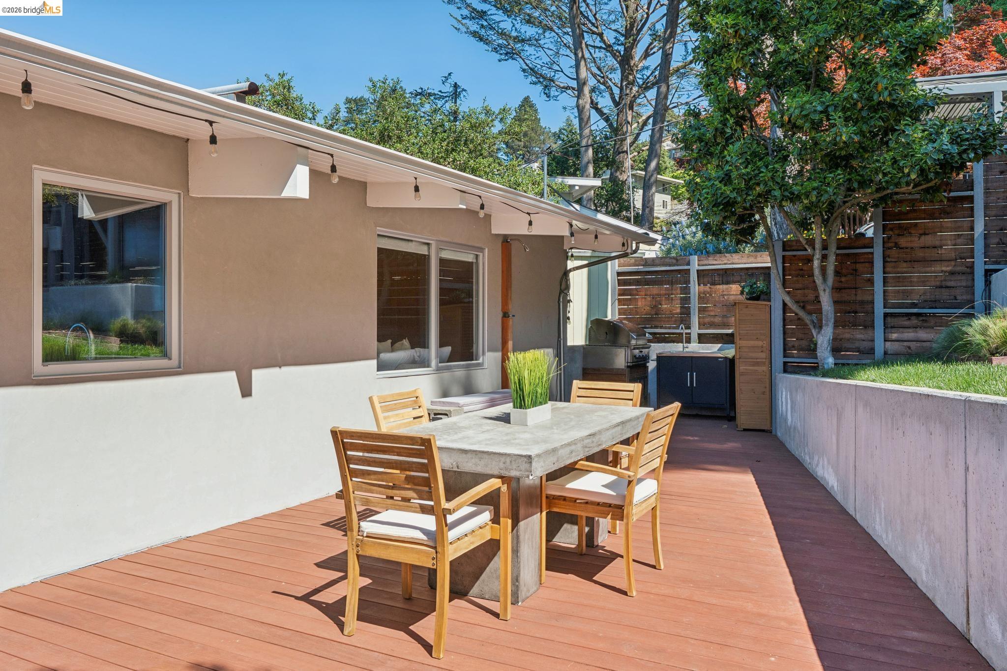 6733 Snake Road Oakland, CA 94611 - Photo 50 of 57 a view of a patio with a table and chairs