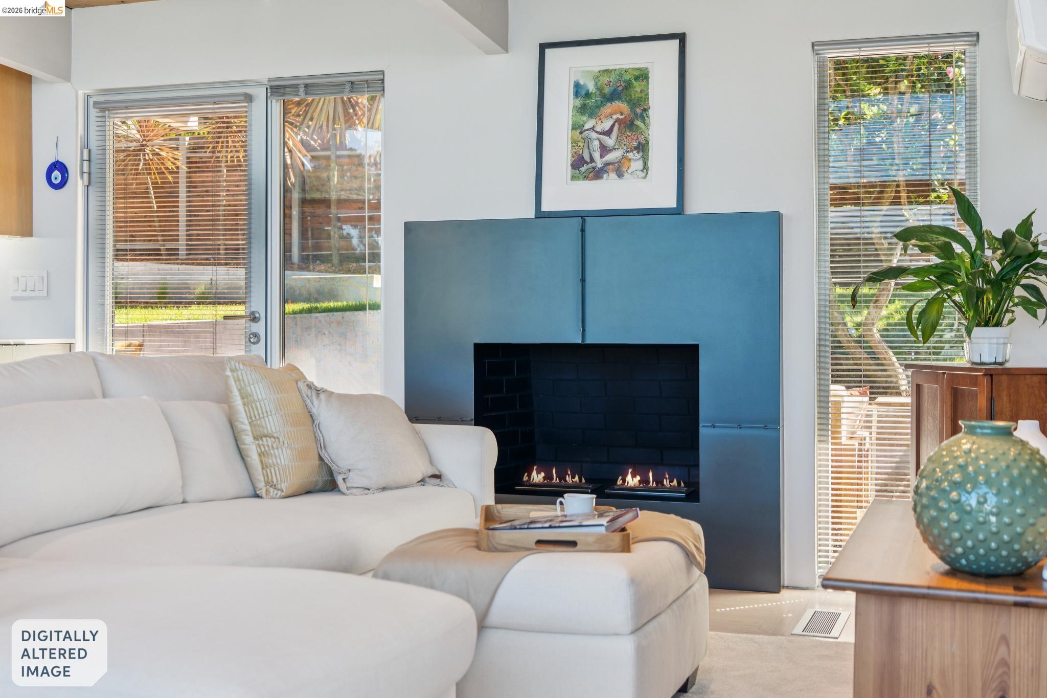 6733 Snake Road Oakland, CA 94611 - Photo 7 of 57 a living room with furniture a flat screen tv and a fireplace