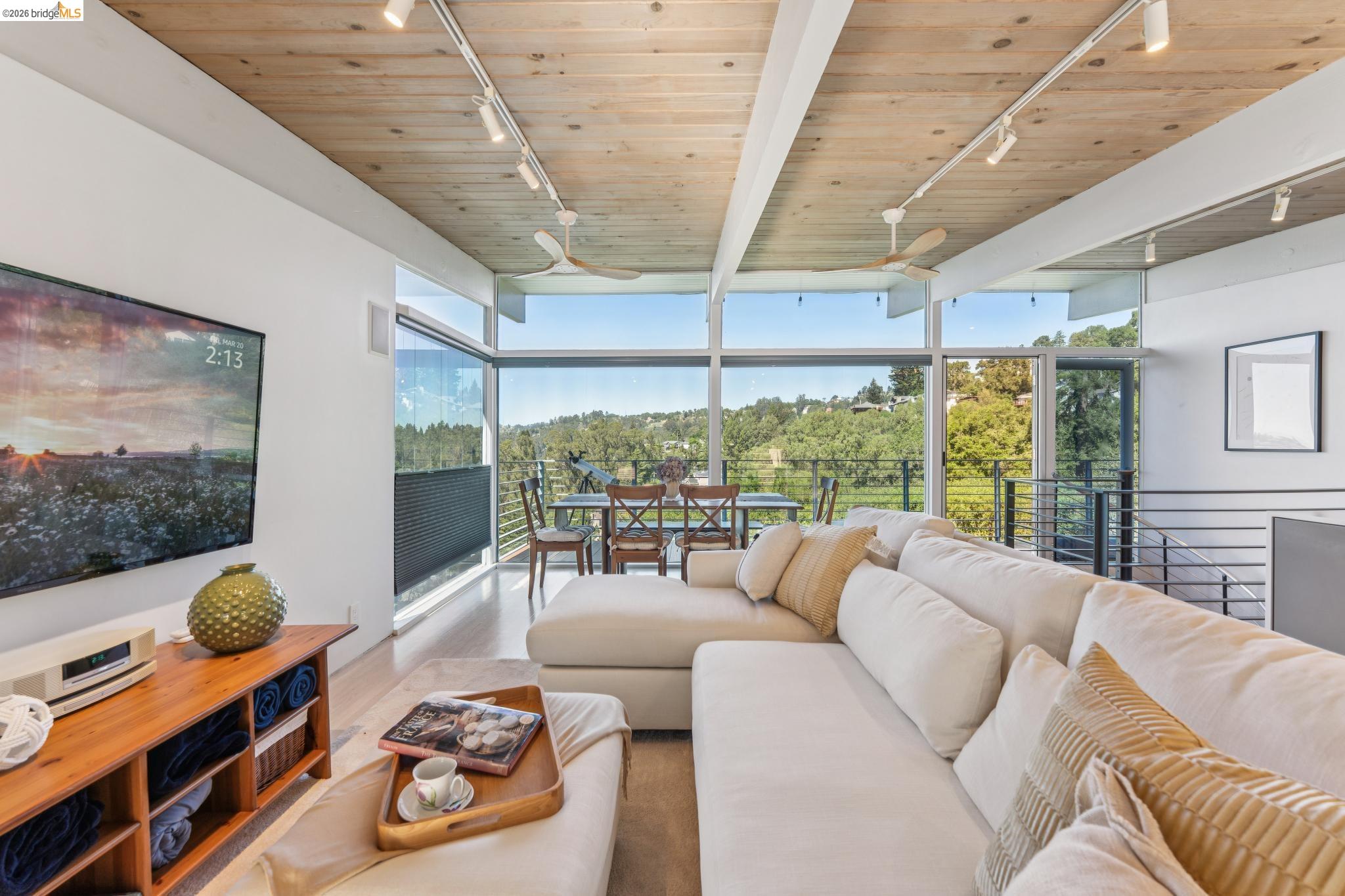 6733 Snake Road Oakland, CA 94611 - Photo 10 of 57 a living room with furniture and a floor to ceiling window