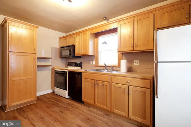 a kitchen with stainless steel appliances granite countertop a refrigerator sink and cabinets