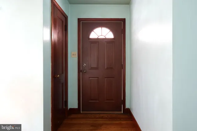 a view of an entryway door with wooden floor