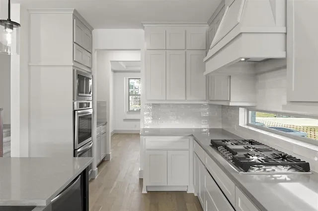 a kitchen with cabinets and appliances