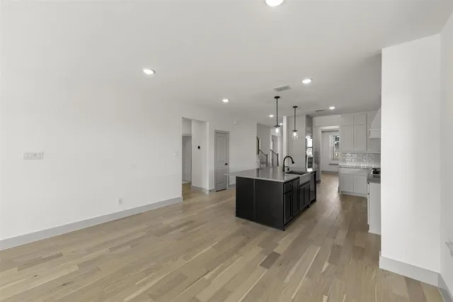 a large room with lots of counter space and wooden floor