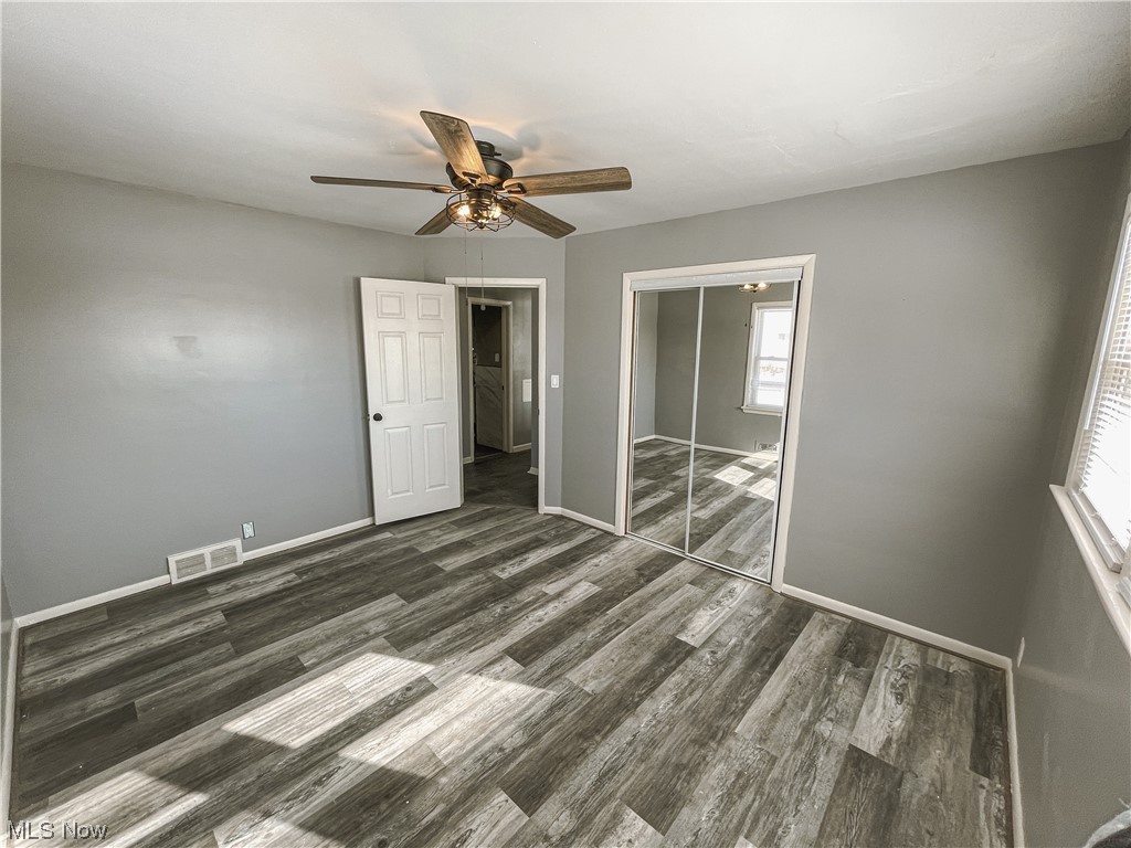 24709 Emery Road Warrensville Heights, OH 44128 - Photo 17 of 34 Unfurnished bedroom featuring a closet, dark hardwood / wood-style flooring, and ceiling fan