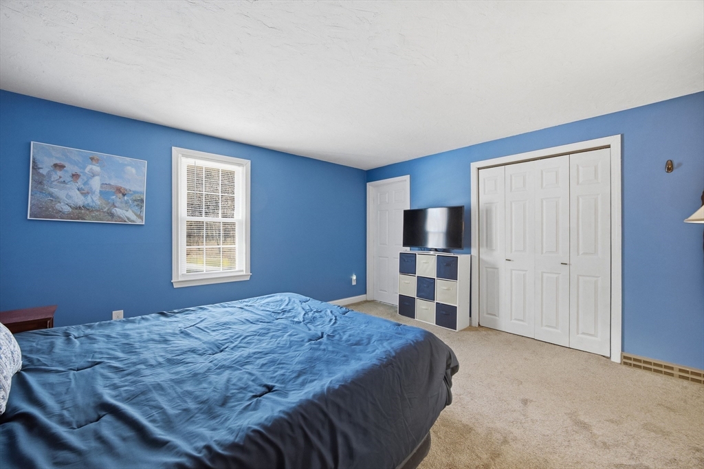 200 Nashua Road Groton, MA 01450 - Photo 28 of 41 a bedroom with a bed and a television in it