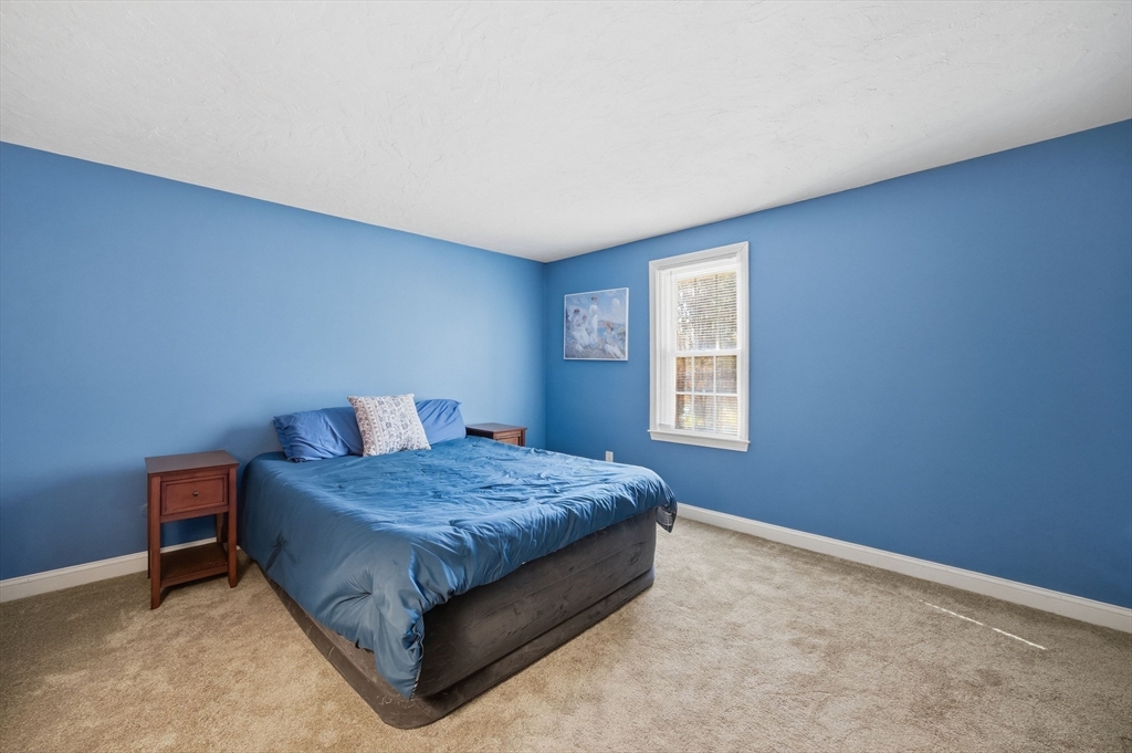 200 Nashua Road Groton, MA 01450 - Photo 29 of 41 a bed sitting in a bedroom next to a window