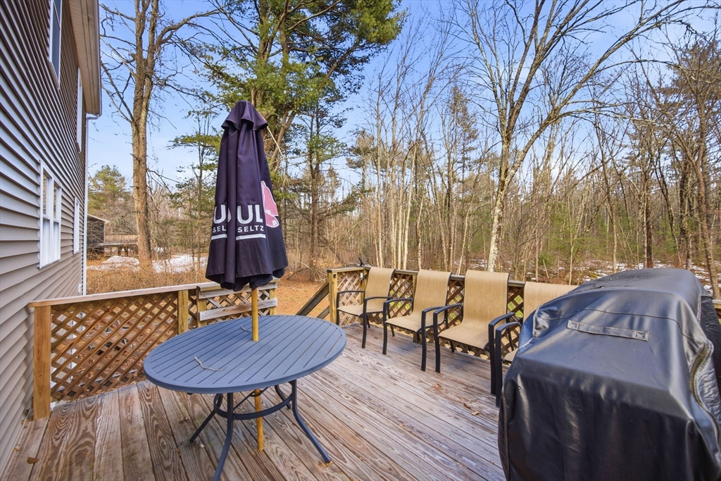 200 Nashua Road Groton, MA 01450 - Photo 4 of 41 a view of a chairs and table in patio with a barbeque