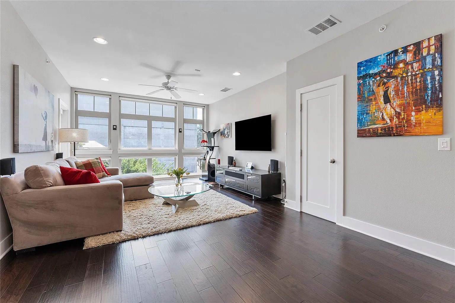 908 Nueces Street, Unit 31 Austin, TX 78701 - Photo 13 of 32 a living room with furniture and a flat screen tv
