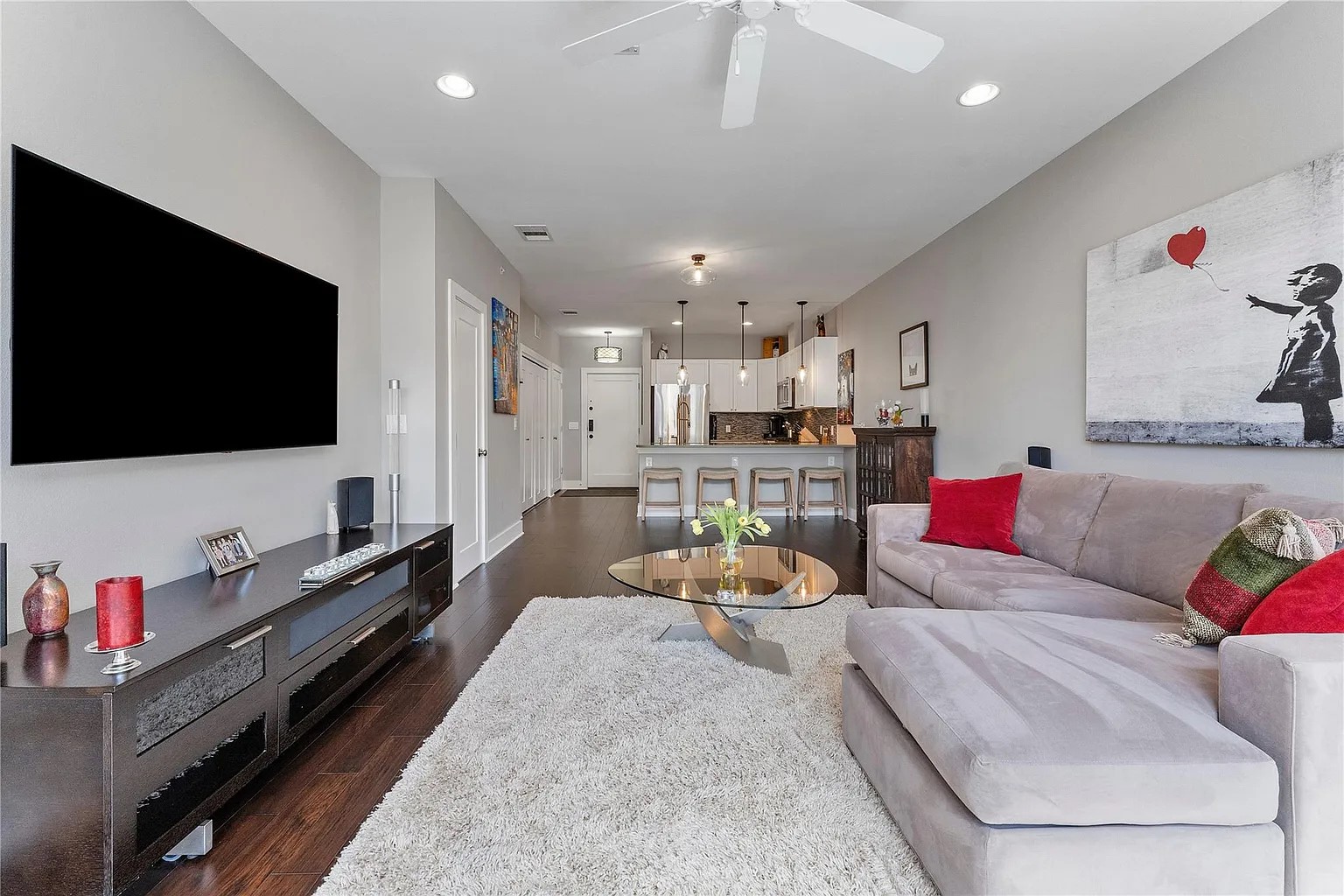 908 Nueces Street, Unit 31 Austin, TX 78701 - Photo 14 of 32 a living room with furniture and a flat screen tv