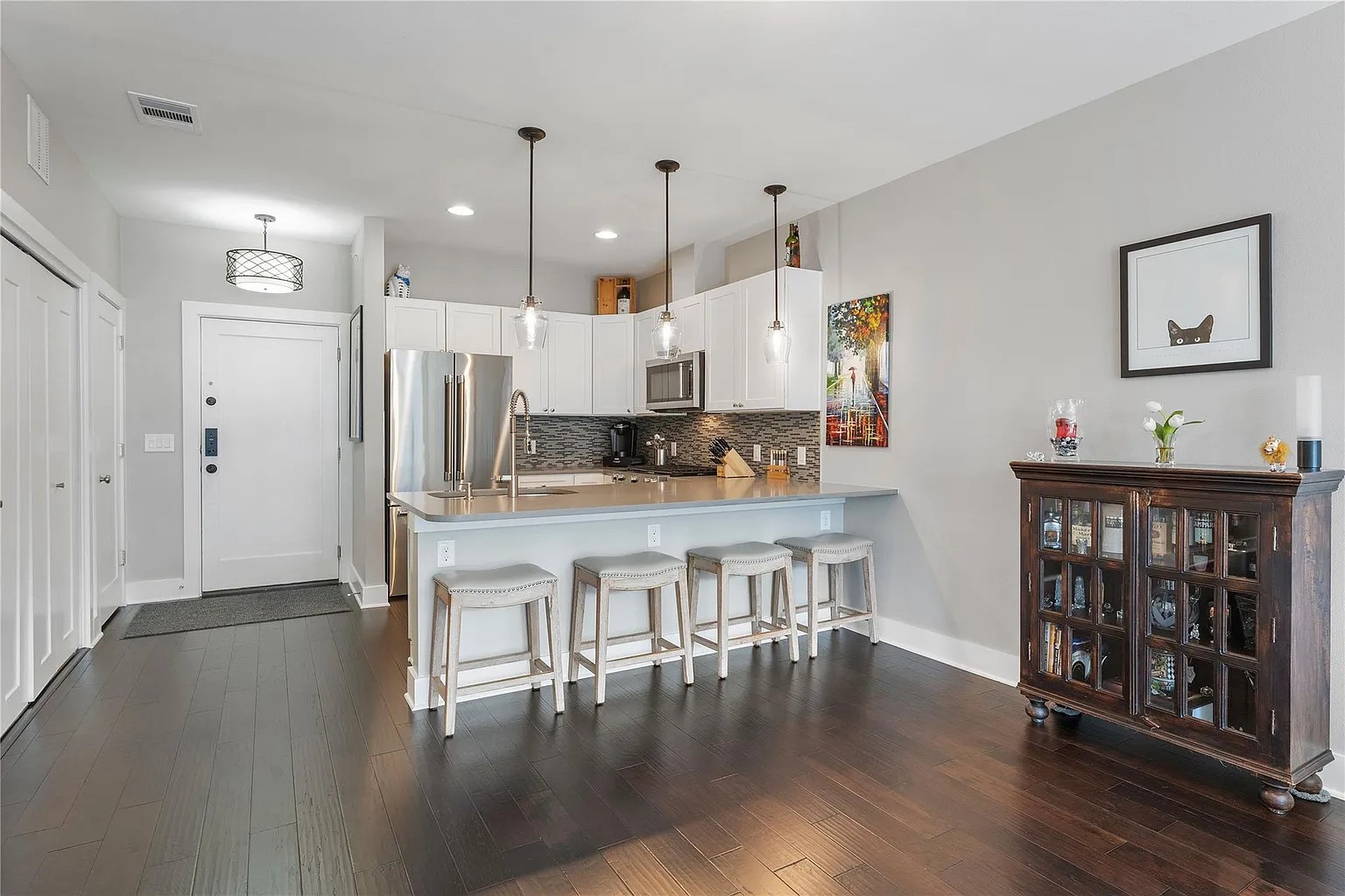 908 Nueces Street, Unit 31 Austin, TX 78701 - Photo 16 of 32 a living room with stainless steel appliances kitchen island wooden floors and view kitchen