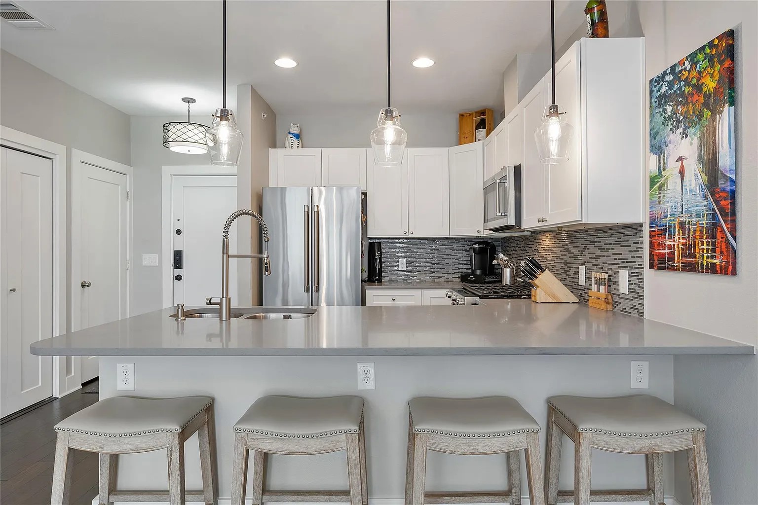 908 Nueces Street, Unit 31 Austin, TX 78701 - Photo 17 of 32 a kitchen with stainless steel appliances granite countertop a sink a stove a refrigerator cabinets and chairs