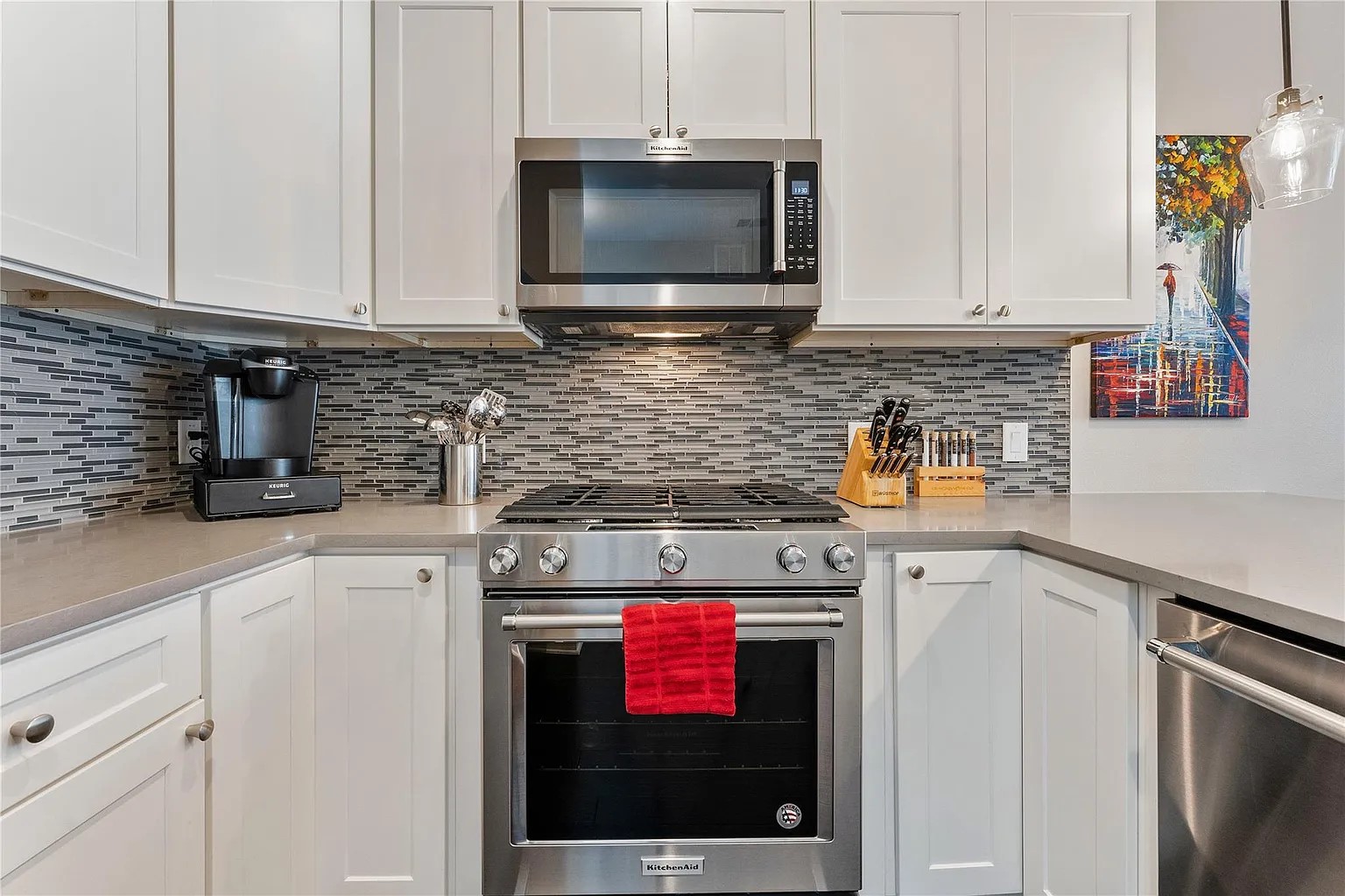 908 Nueces Street, Unit 31 Austin, TX 78701 - Photo 19 of 32 a kitchen with stainless steel appliances granite countertop a stove a microwave and cabinets