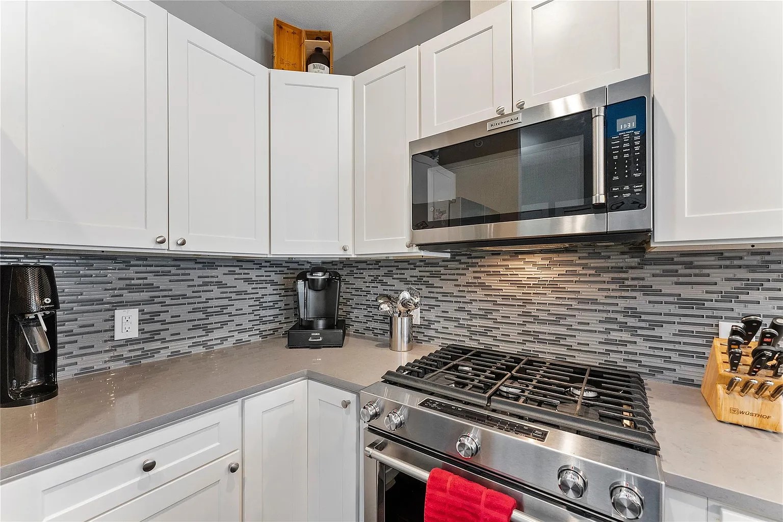 908 Nueces Street, Unit 31 Austin, TX 78701 - Photo 20 of 32 a kitchen with granite countertop stainless steel appliances a sink a stove and cabinets