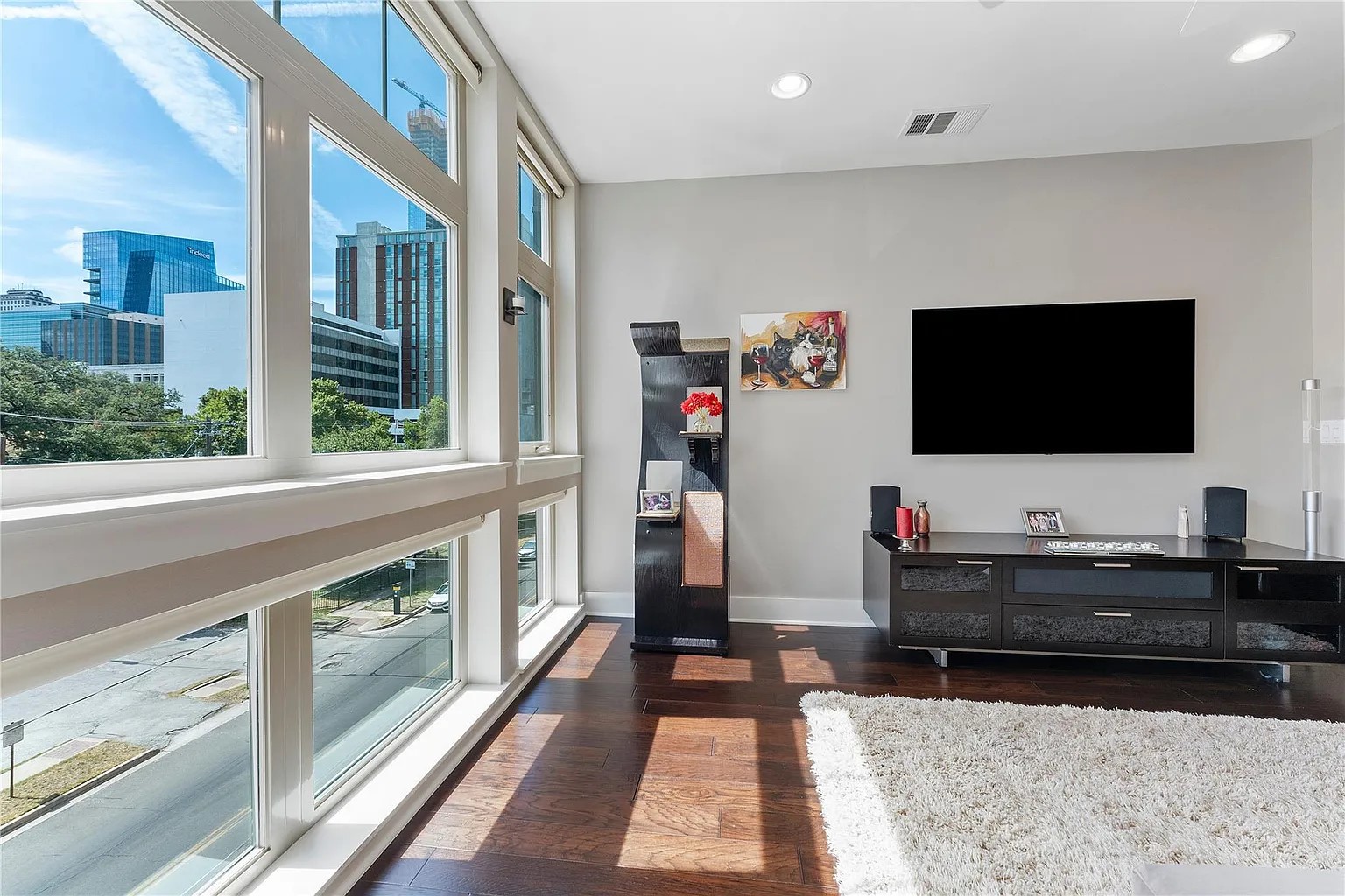 908 Nueces Street, Unit 31 Austin, TX 78701 - Photo 7 of 32 a living room with a flat screen tv
