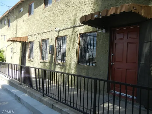 a view of a house with a wooden fence