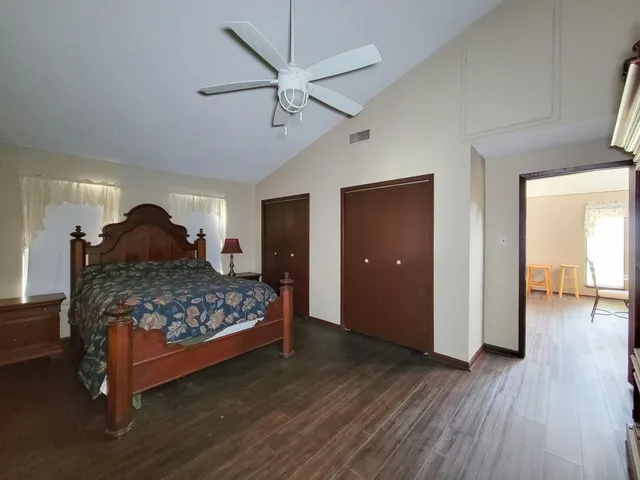 a room with a bed and wooden floor
