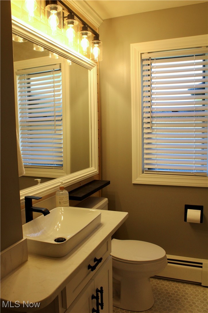 24836 Kennedy Ridge Road North Olmsted, OH 44070 - Photo 22 of 29 Bathroom with vanity, tile patterned flooring, a baseboard heating unit, and toilet