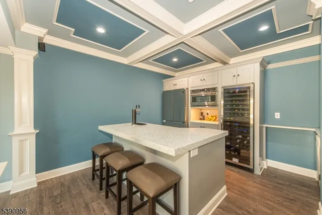 a kitchen with stainless steel appliances kitchen island granite countertop a refrigerator and a stove