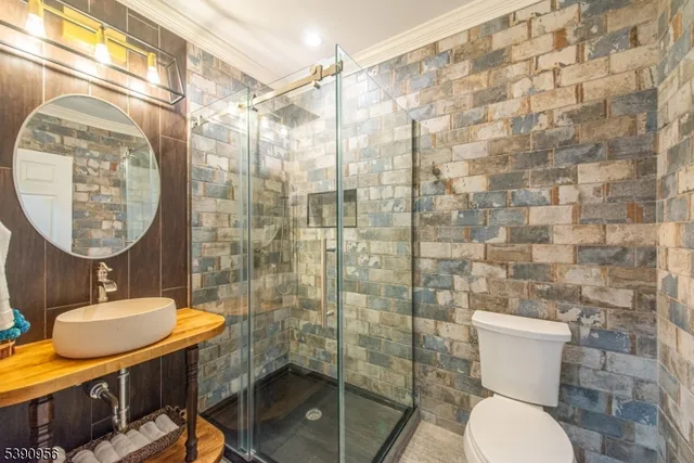 a bathroom with a toilet a sink and mirror