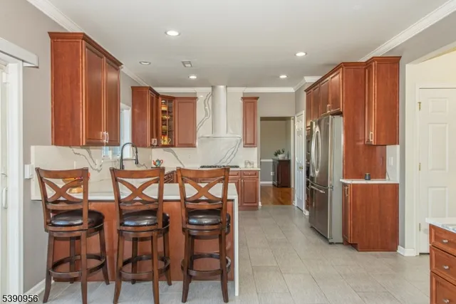 a kitchen with kitchen island granite countertop a sink window and cabinets