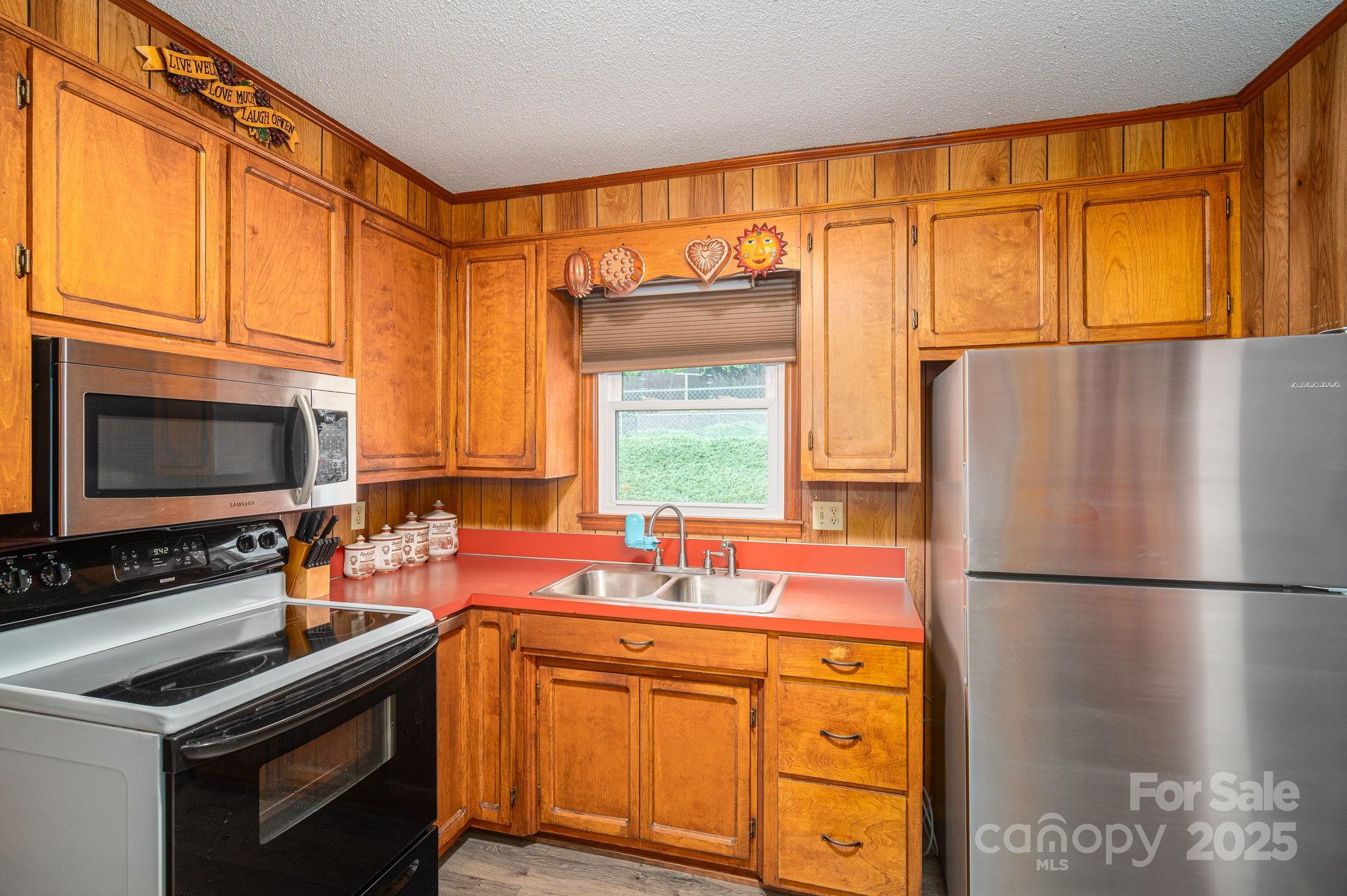 3076 Gates Road Lincolnton, NC 28092 - Photo 11 of 36 a kitchen with stainless steel appliances a stove sink and refrigerator